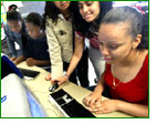 teenagers grouped around a computer