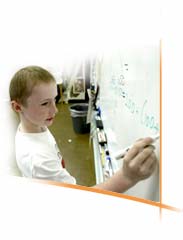 boy working on an equation at the board